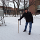 The author measuring the paltry three inches at his observation location in Pennsylvania. Note the instrument shelters in the background.